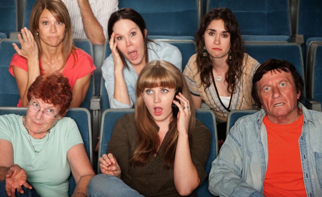 woman on phone call in theater
