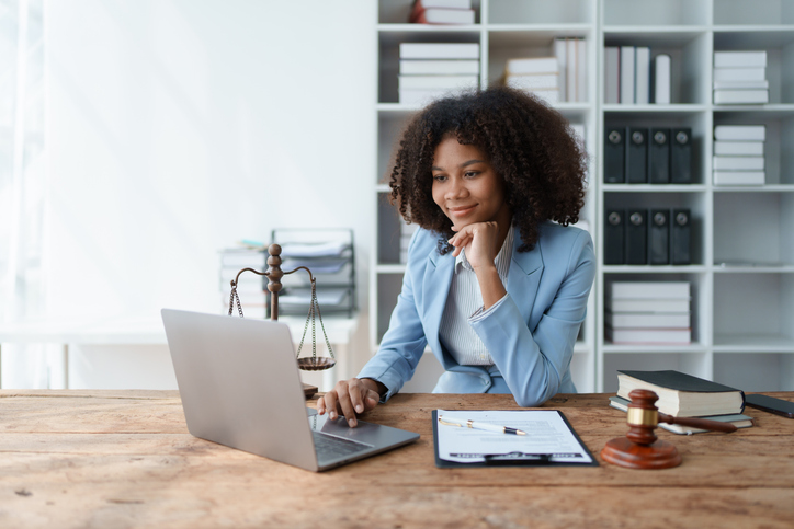Lawyer reading over email marketing campaign for her firm